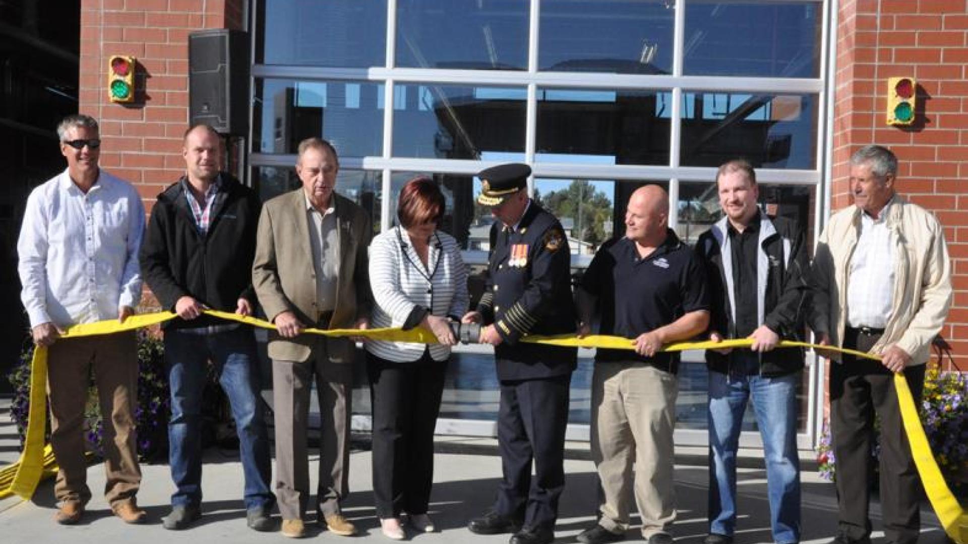 Ceremonial fire hose uncoupling indicating the opening of the new fire station.