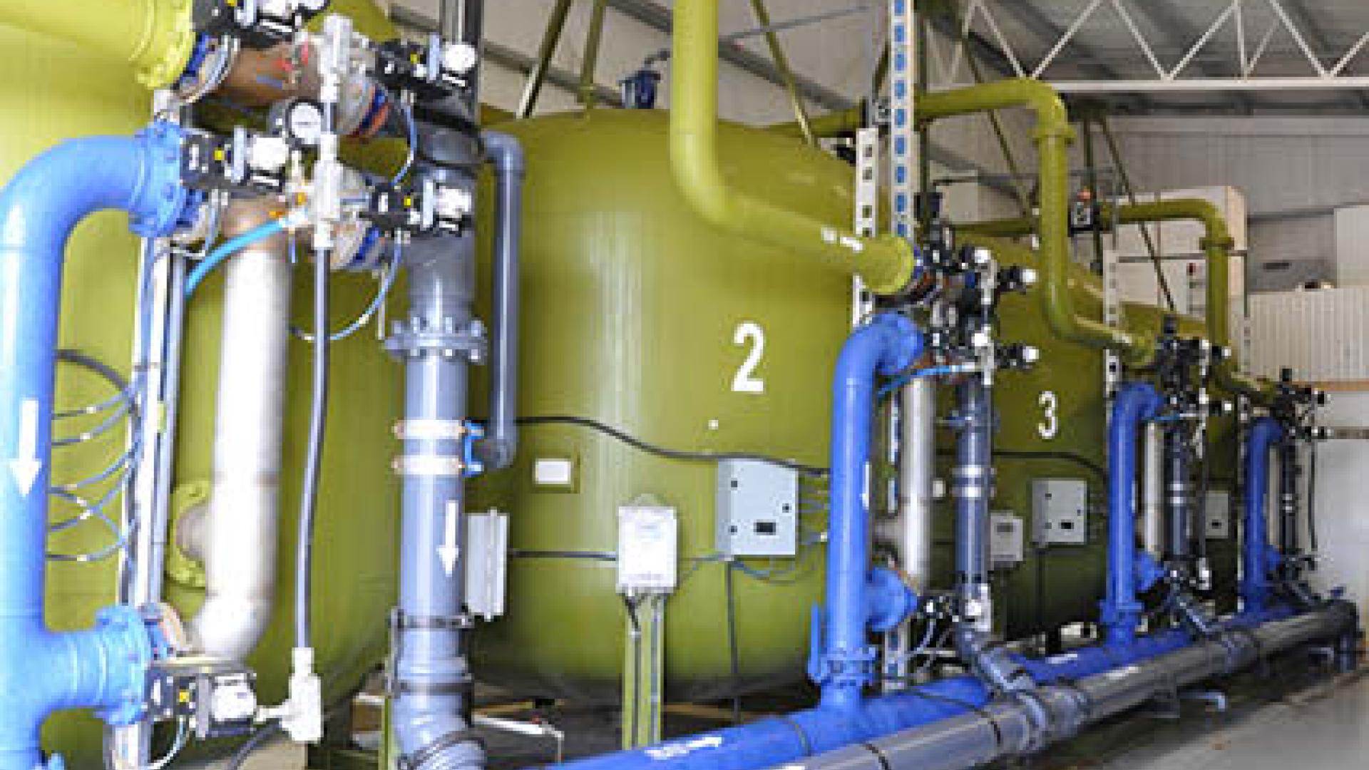 Water treatment pumps housed inside a building.