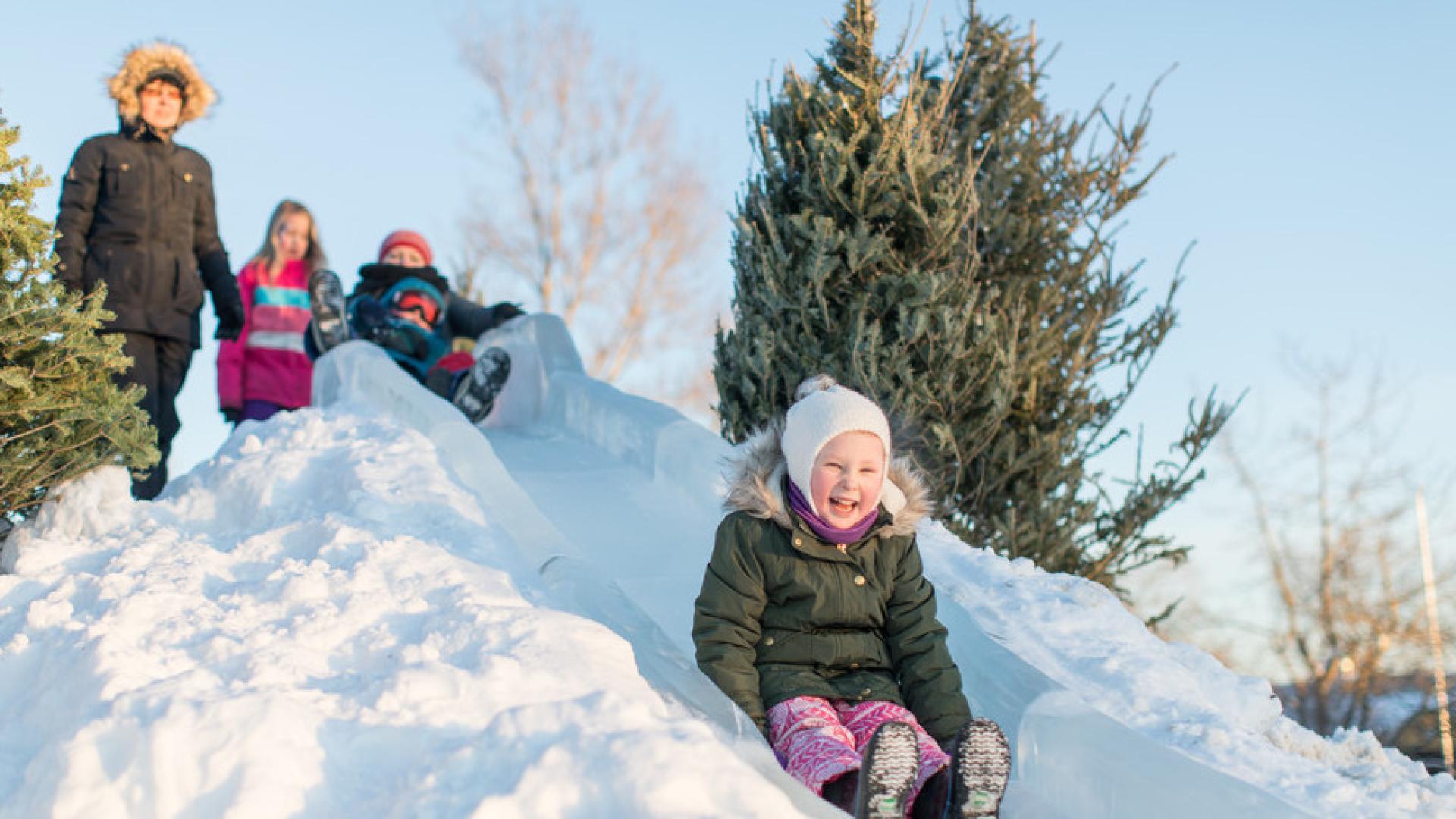 A child slides down the ice slides at the High on Ice Winter Festival.