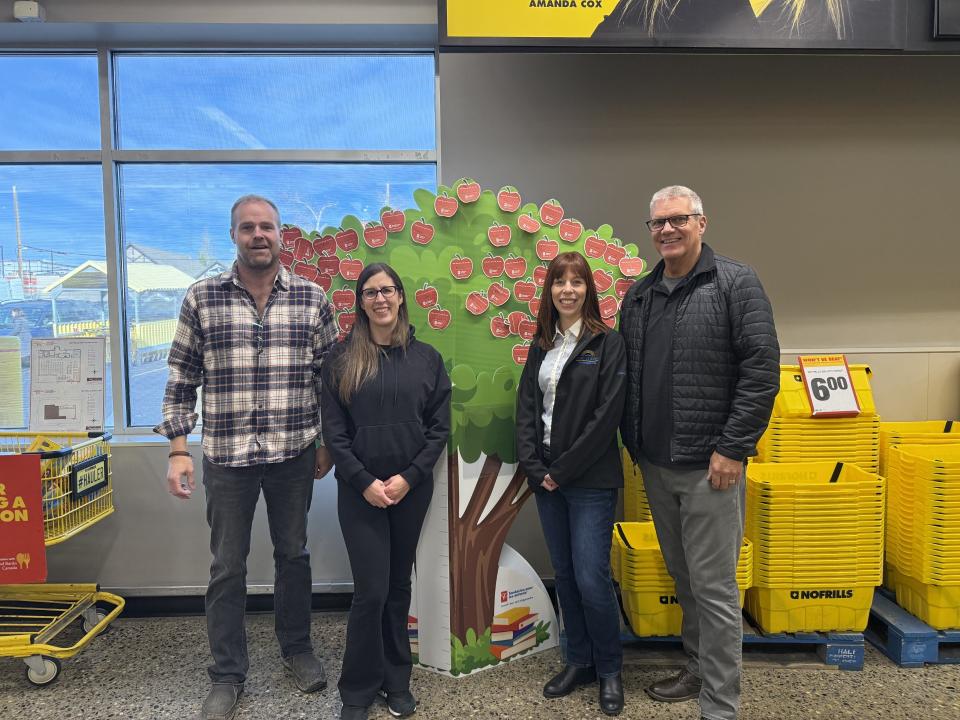 Members of Council's Response Committee stand with the owner of No Frills in Fort St. John.